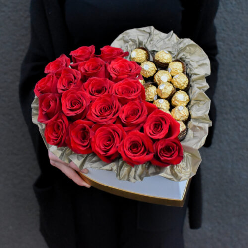 Raudonos rožės širdelės formos dėžutėje su saldainiais